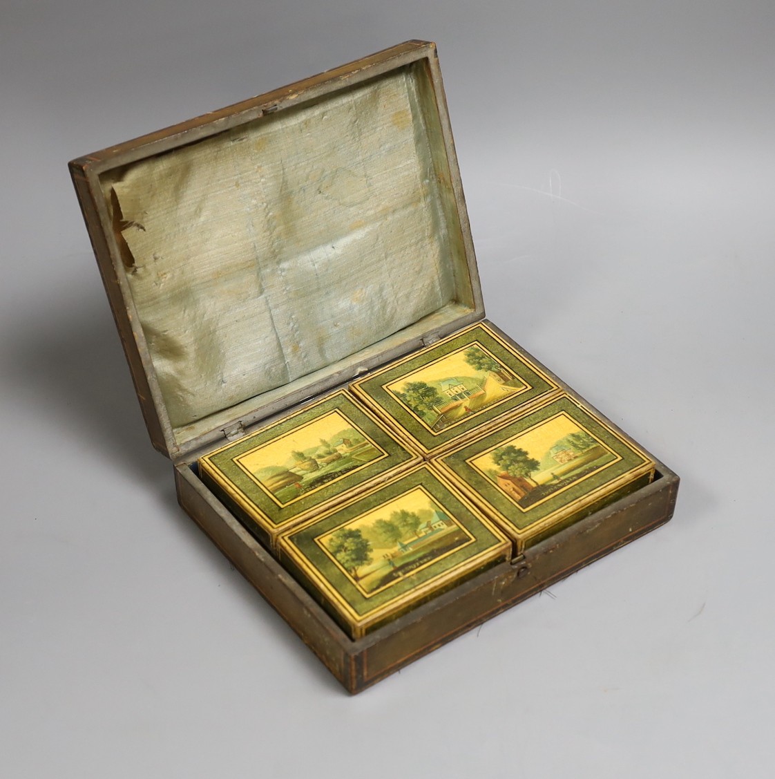 A 19th century Belgian stained sycamore box containing four counter boxes with named views, with mother of pearl fish shaped and circular gaming counters